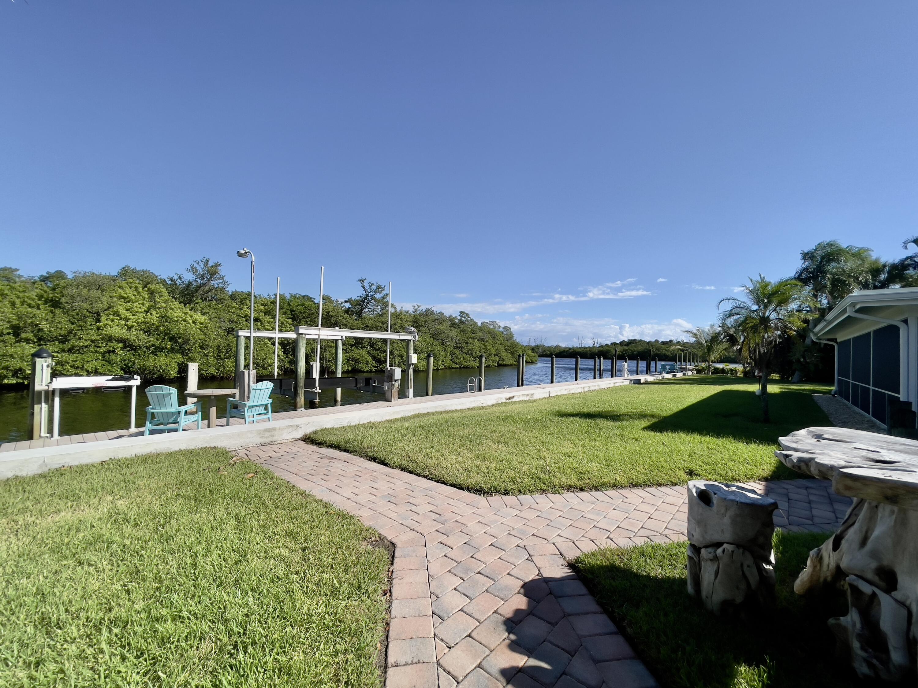 8585 Southeast Palm Street Hobe Sound, FL 33455 - Photo 29 of 43 a view of a house with a yard