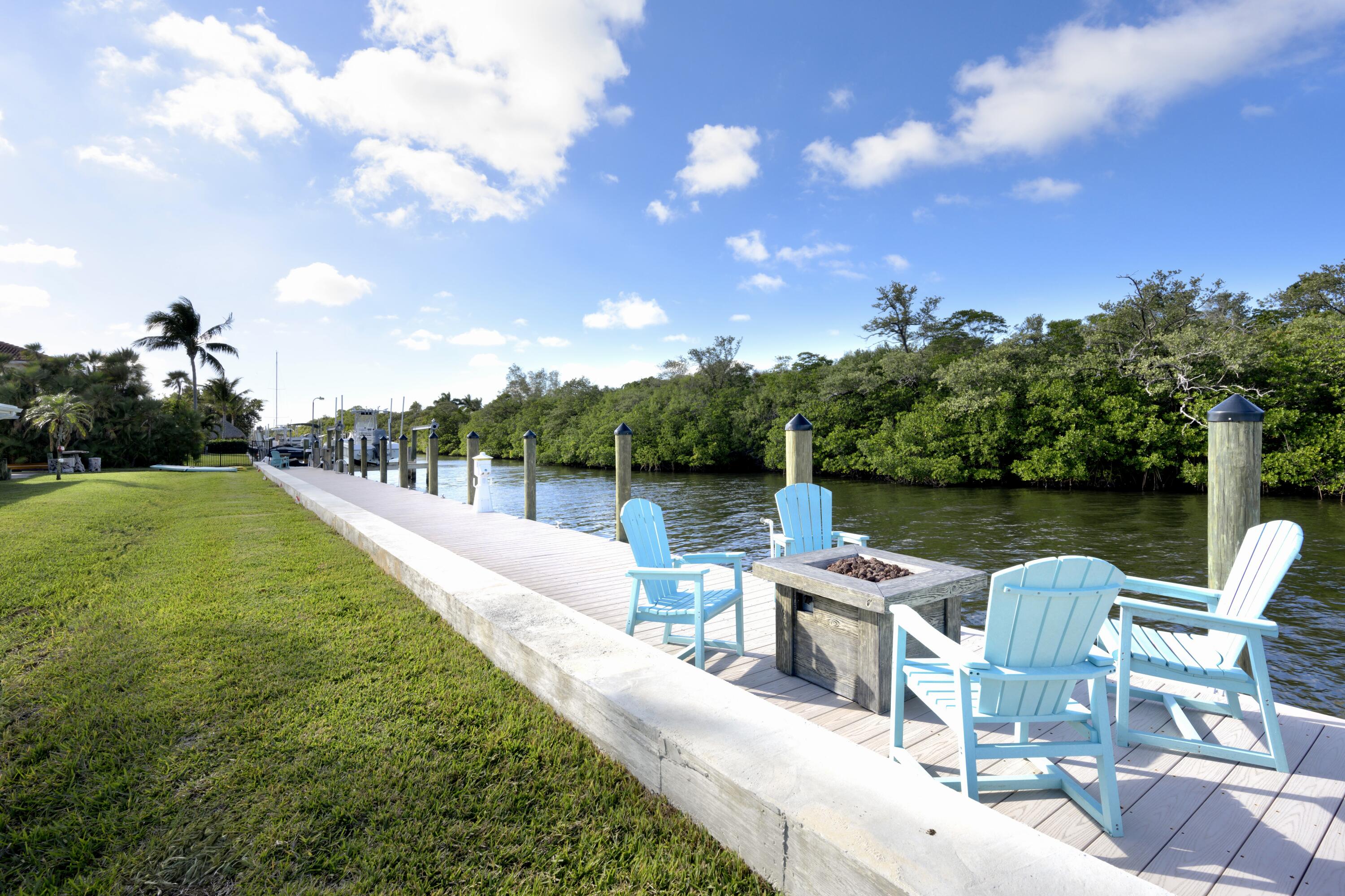 8585 Southeast Palm Street Hobe Sound, FL 33455 - Photo 32 of 43 a view of a lake with a garden