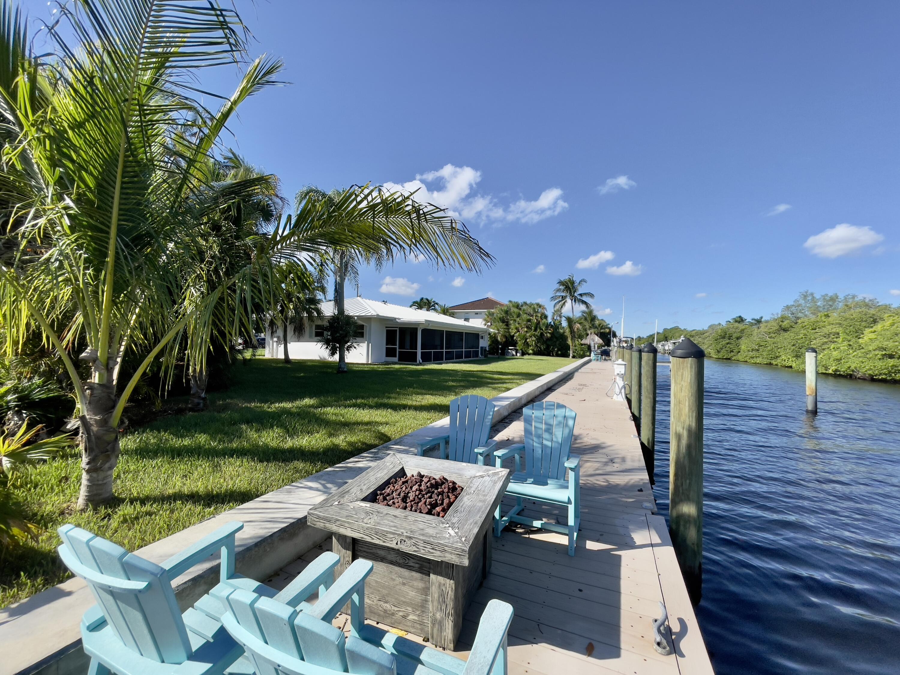 8585 Southeast Palm Street Hobe Sound, FL 33455 - Photo 33 of 43 a view of a wooden deck and a garden