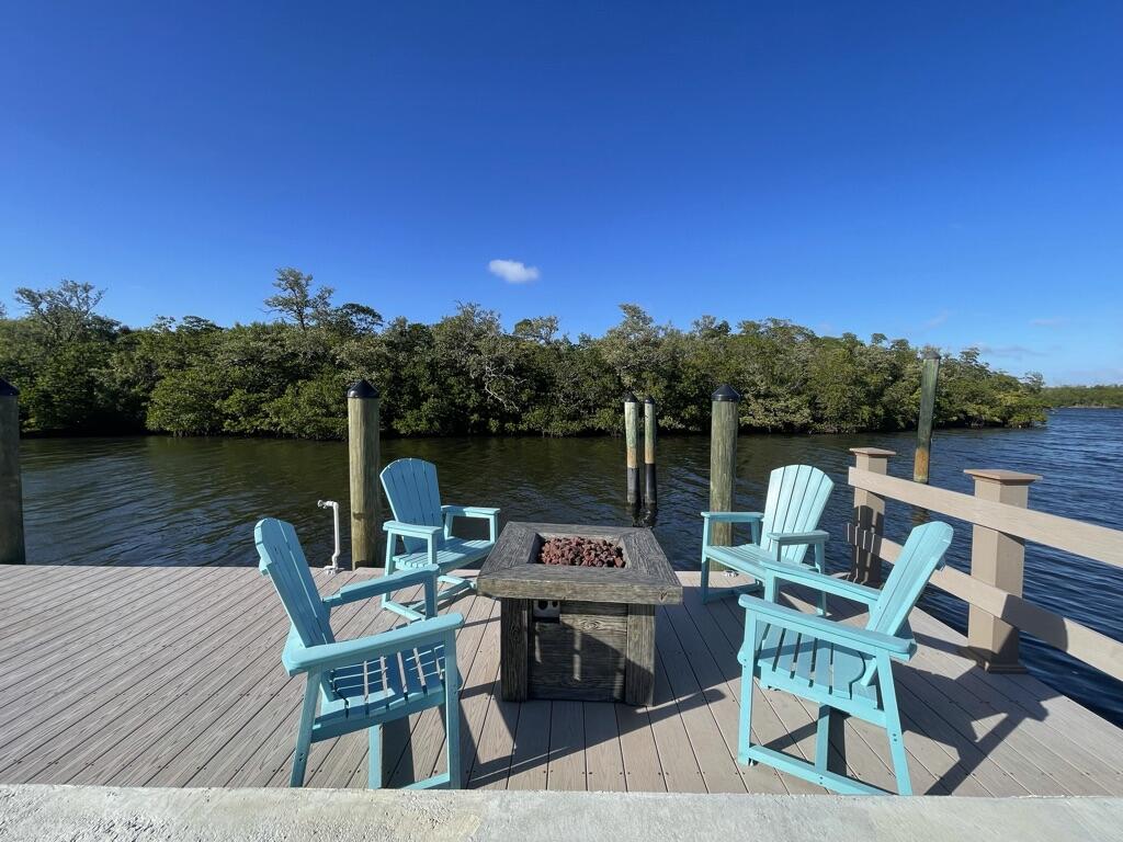 8585 Southeast Palm Street Hobe Sound, FL 33455 - Photo 34 of 43 a view of a chairs and table in the patio
