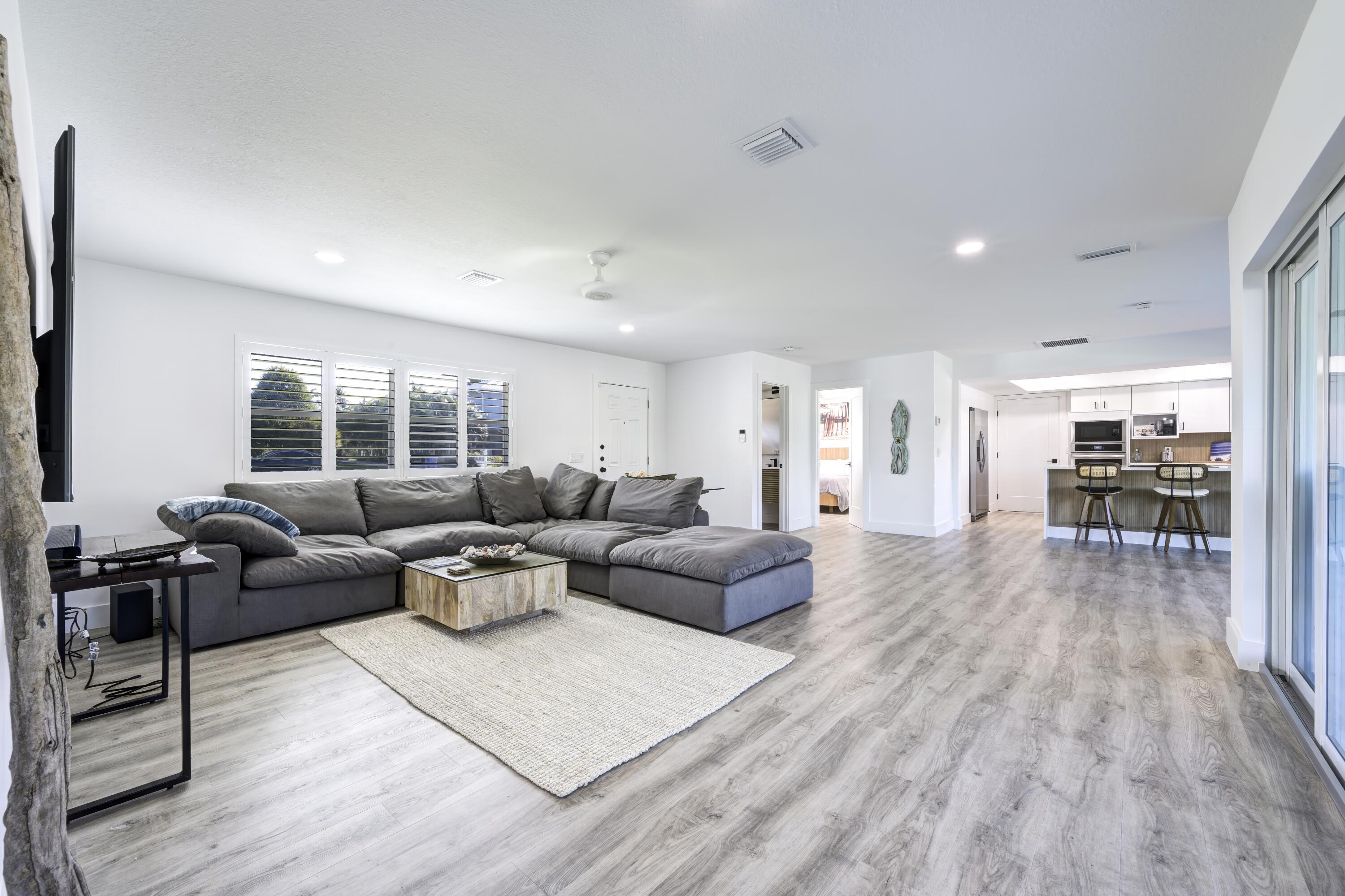 8585 Southeast Palm Street Hobe Sound, FL 33455 - Photo 6 of 43 a living room with furniture and a wooden floor