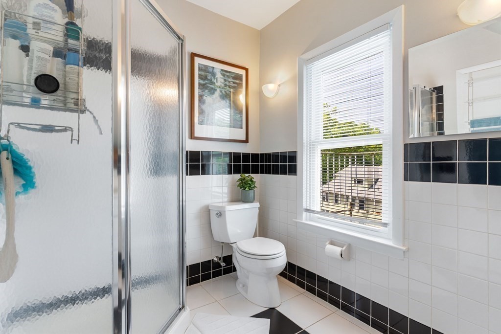 47 R Jamaica Street, Unit 3 Boston, MA 02130 - Photo 12 of 16 a bathroom with a toilet a sink and a window