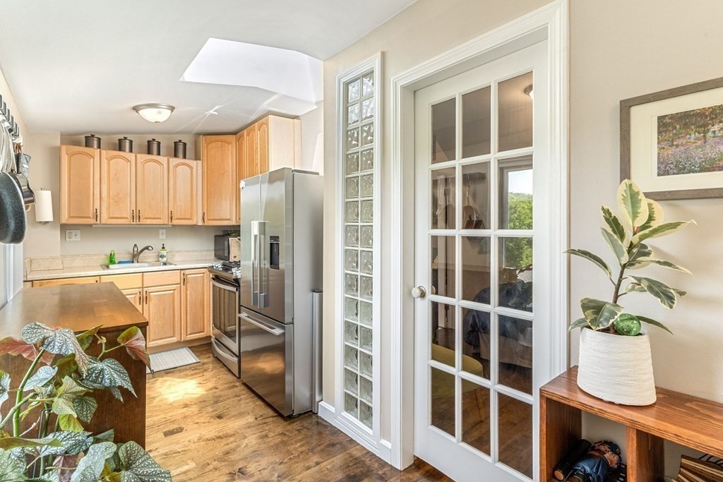 47 R Jamaica Street, Unit 3 Boston, MA 02130 - Photo 4 of 16 a kitchen with a refrigerator and a window