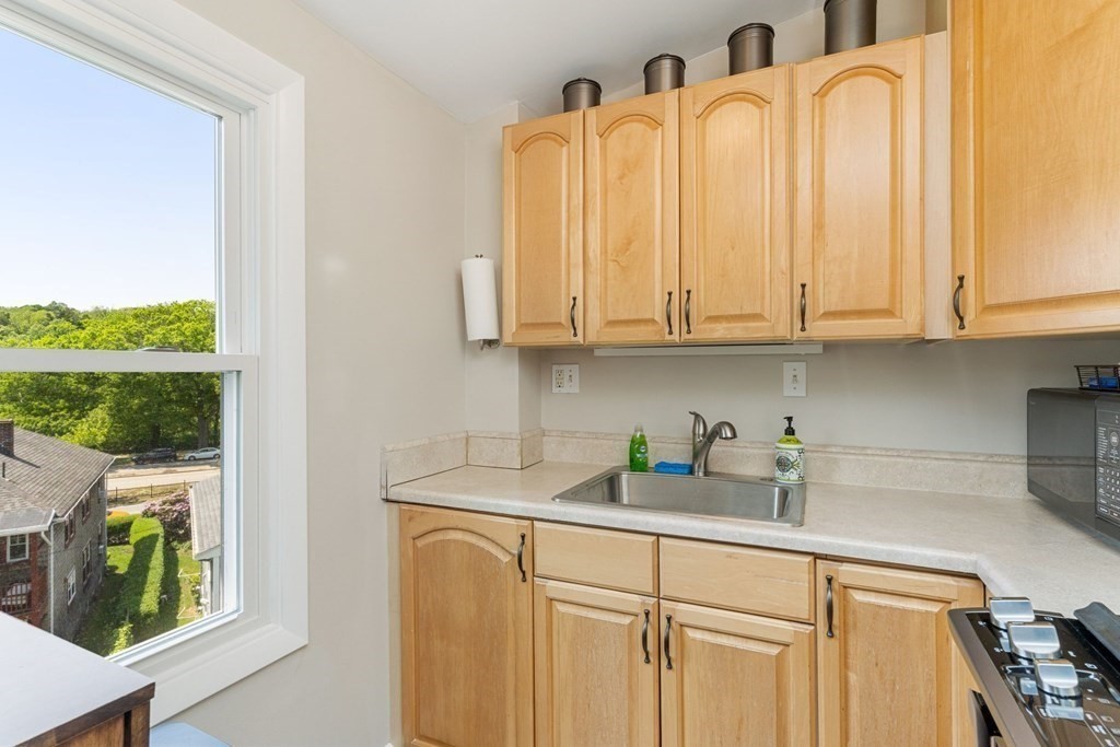 47 R Jamaica Street, Unit 3 Boston, MA 02130 - Photo 6 of 16 a kitchen with stainless steel appliances granite countertop a sink a cabinets and a window
