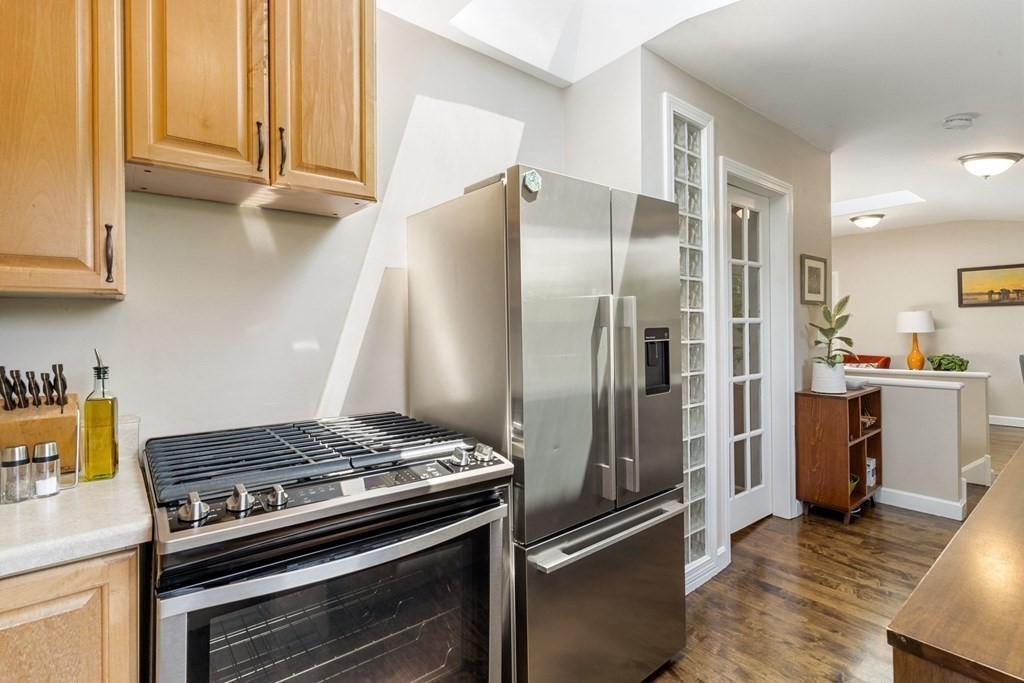 47 R Jamaica Street, Unit 3 Boston, MA 02130 - Photo 7 of 16 a kitchen with stainless steel appliances granite countertop a refrigerator and a stove