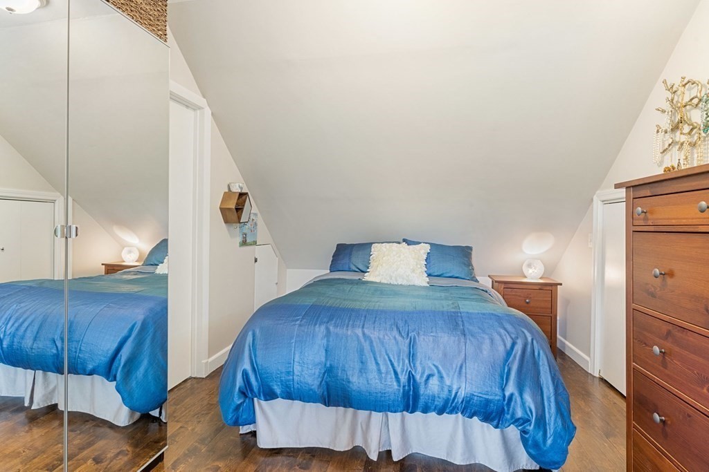 47 R Jamaica Street, Unit 3 Boston, MA 02130 - Photo 9 of 16 a bedroom with a bed and a mirror