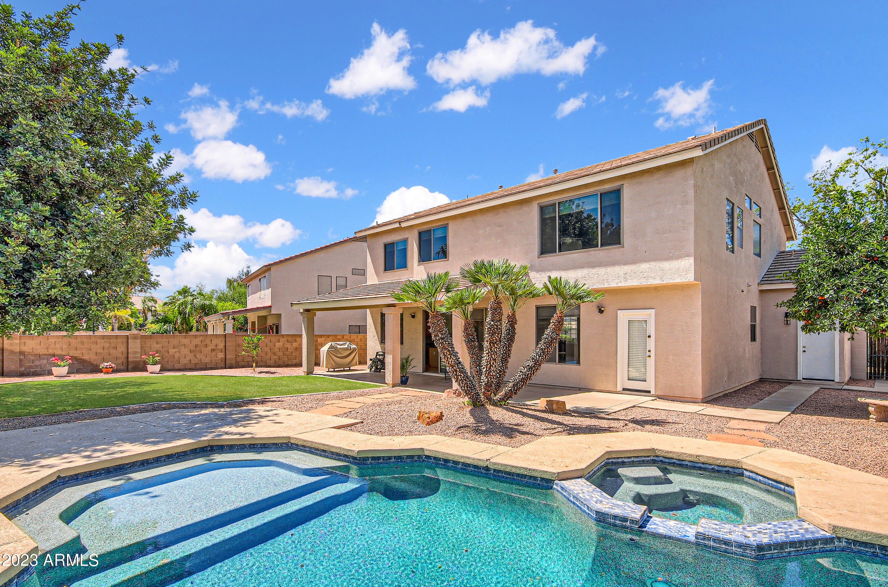 1885 East Smoke Tree Road Gilbert, AZ 85296 - Photo 3 of 3 a house view with swimming pool and wooden bench