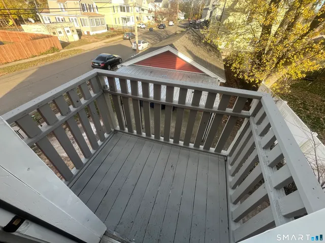 a kitchen with wooden floor and electronic appliances