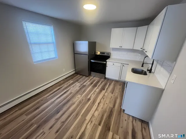 a kitchen with a sink and a stove top oven