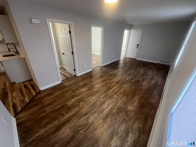 a bathroom with a sink mirror and toilet