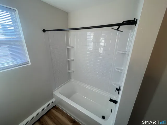 a bathroom with a bathtub and a shower