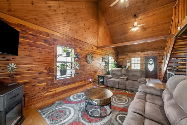 a kitchen with stainless steel appliances granite countertop a table chairs and a refrigerator
