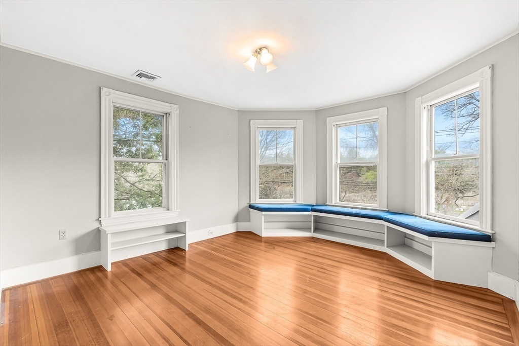 207 Weston Road Wellesley, MA 02482 - Photo 18 of 23 a view of an empty room with wooden floor and a window