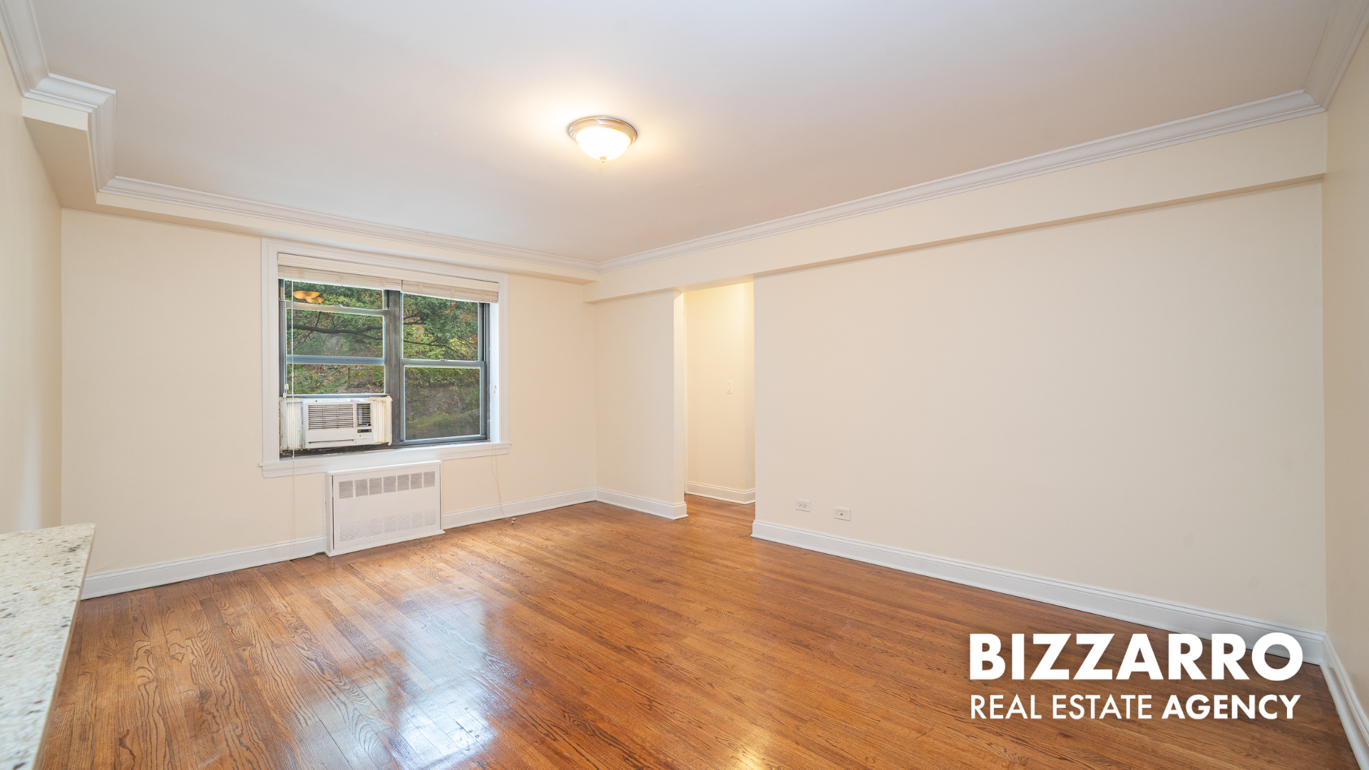 Undisclosed Address Manhattan, NY 10040 - Photo 3 of 10 an empty room with wooden floor and windows