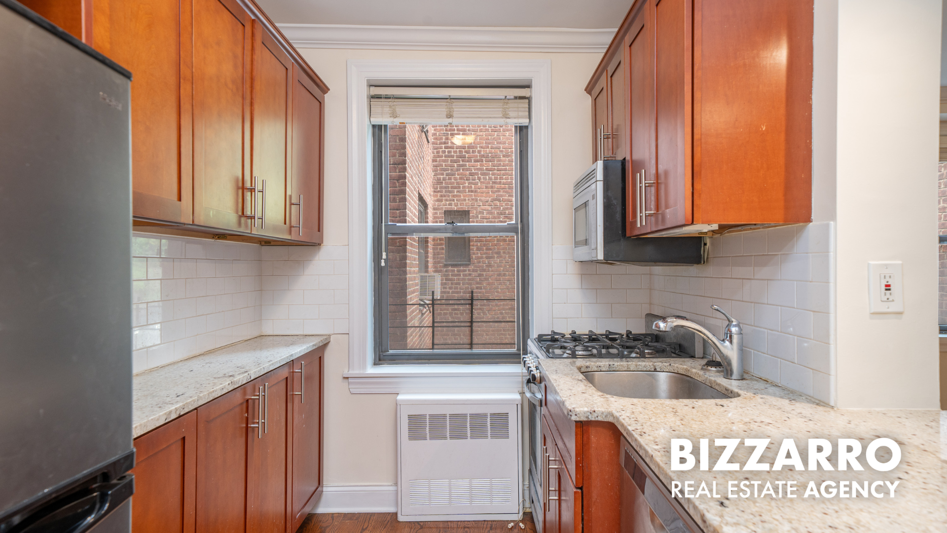 Undisclosed Address Manhattan, NY 10040 - Photo 5 of 10 a kitchen with granite countertop a sink a stove and cabinets