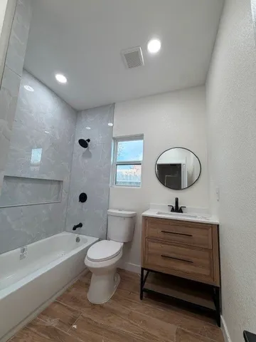 a bathroom with a toilet a sink and a bathtub