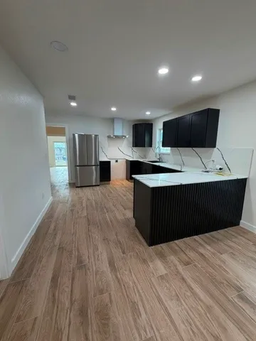 a kitchen with a sink and a mirror
