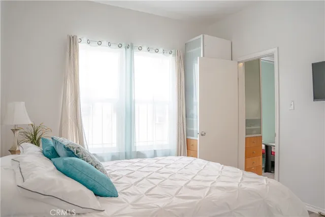 a bedroom with a bed window and a bed