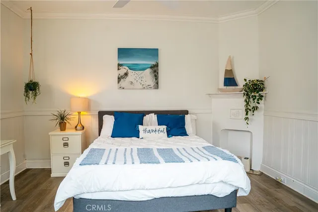 a bedroom with a bed and a potted plant