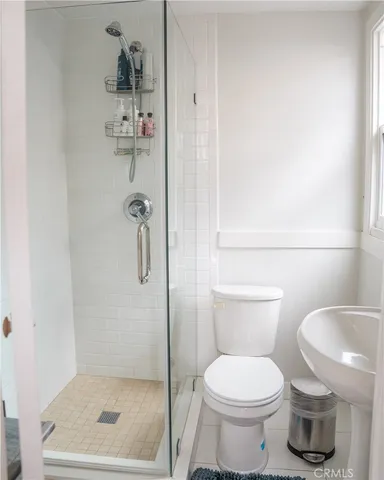 a bathroom with a toilet and a shower