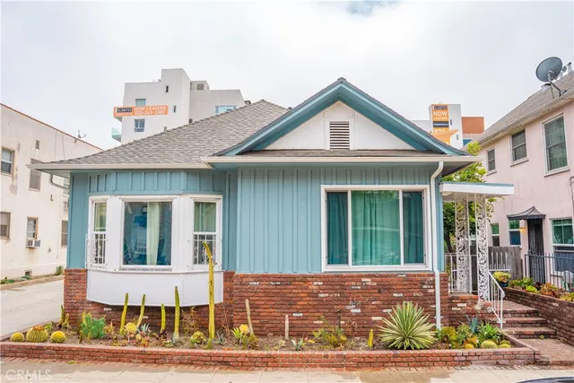 a front view of a house with garden