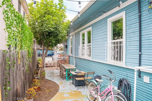 a view of a patio with couches chairs and potted plants