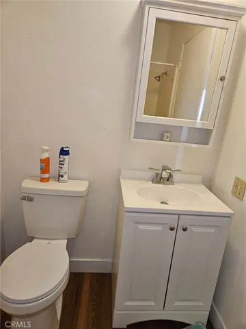 a bathroom with a toilet a sink and a mirror