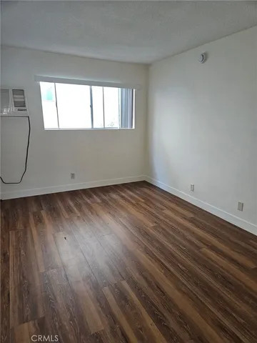 a view of wooden floor and windows in a room