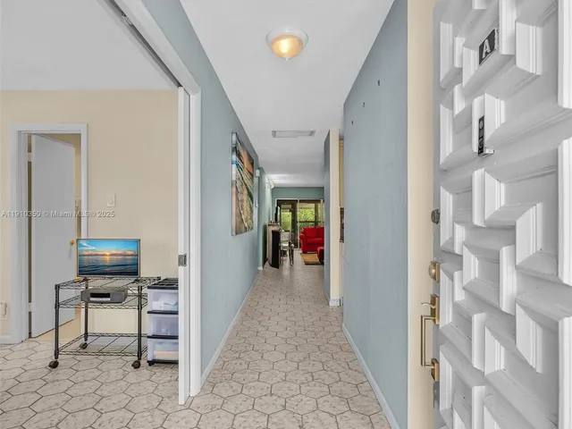 a view of a hallway with seating area