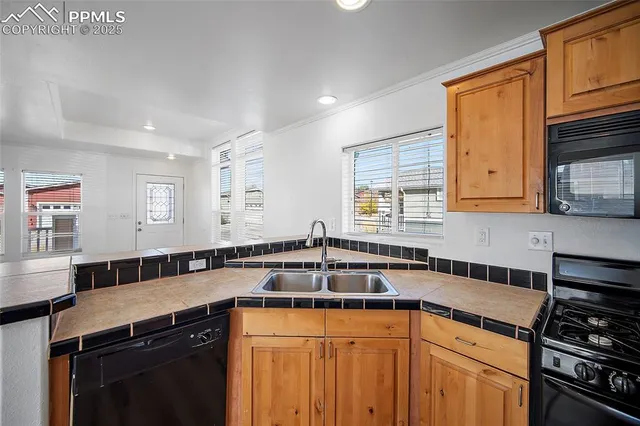 a kitchen with a sink stove and cabinets