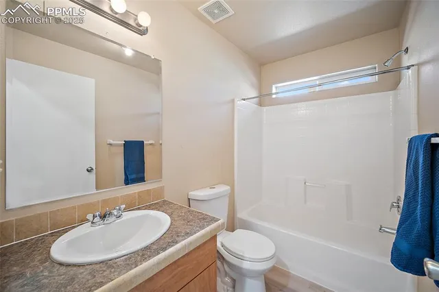 a view of a room with wooden floor and a sink