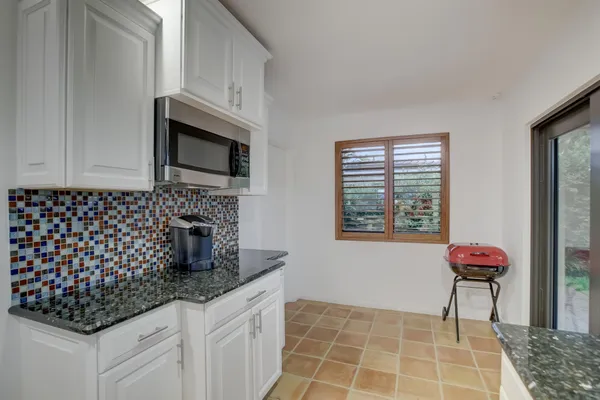 a kitchen with stainless steel appliances a sink a stove a microwave and cabinets