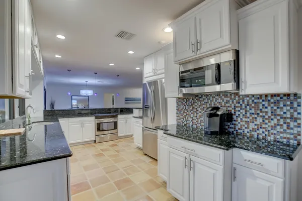a kitchen with a sink stove and microwave