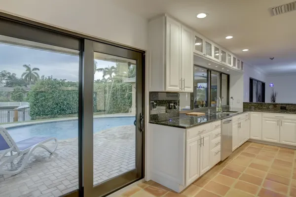 a kitchen with stainless steel appliances granite countertop a stove and a sink