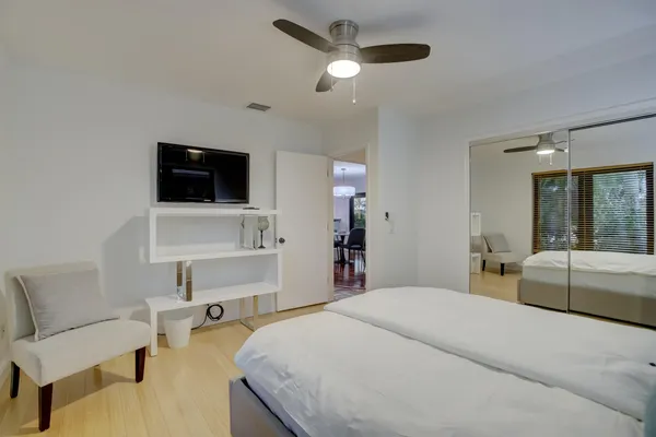 a bedroom with a bed and a flat screen tv