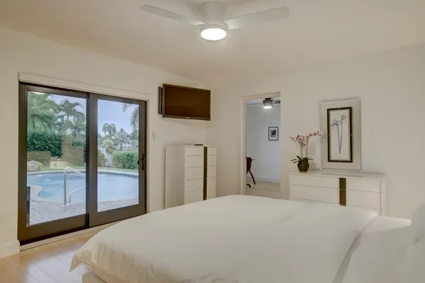 a bedroom with a large bed and a flat tv screen