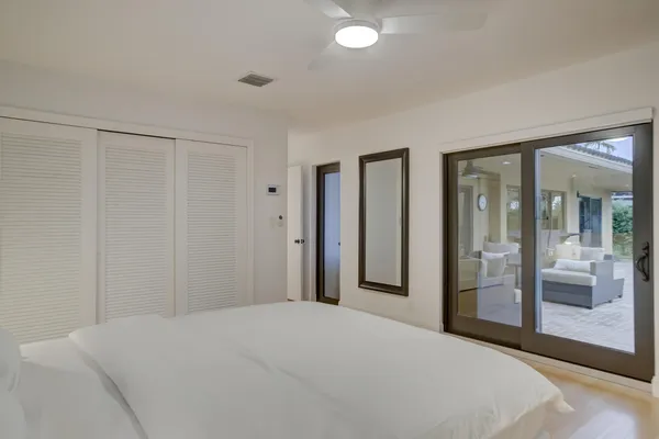 a bedroom with a bed and a large mirror