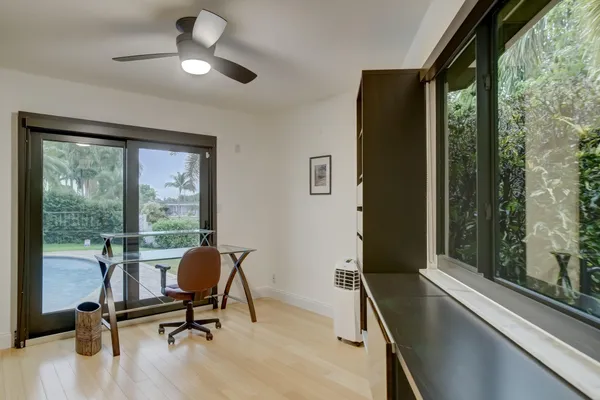 a view of a workspace with furniture and a window