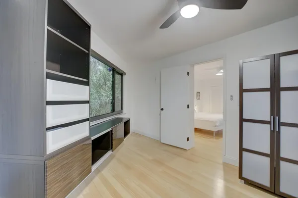 a view of gallery with wooden floor and window