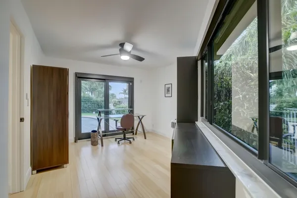 a view of a workspace with furniture and a window