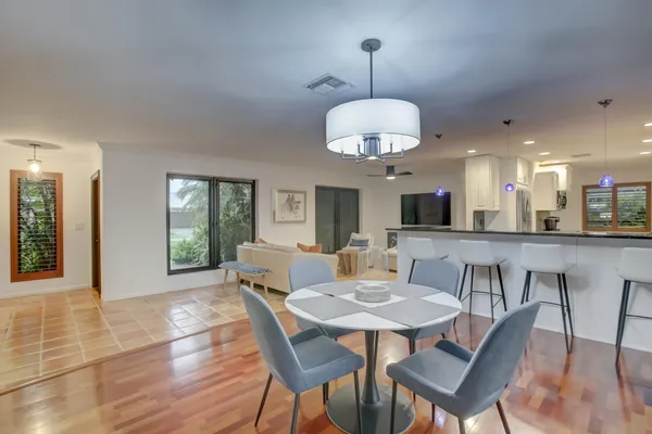 a view of a dining room with furniture wooden floor and chandelier