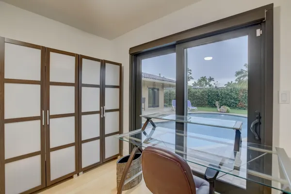 a view of a room with wooden floor and windows