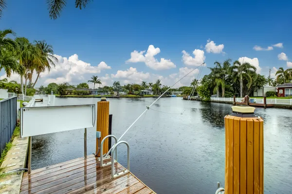 a view of a lake with tables and chairs