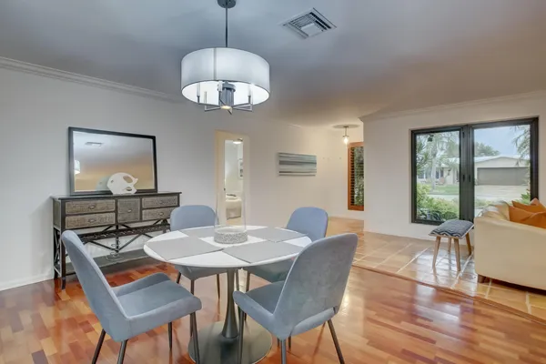 a view of a dining room with furniture window and wooden floor