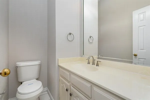 a bathroom with a sink toilet and vanity