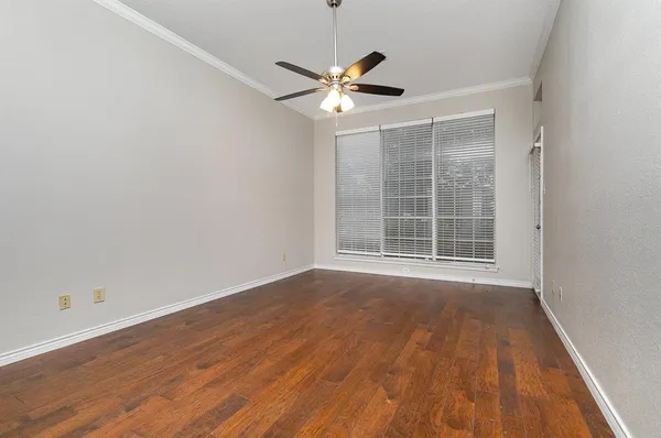 a view of a livingroom with a ceiling fan and wooden floor