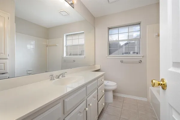 a bathroom with a sink a toilet and window