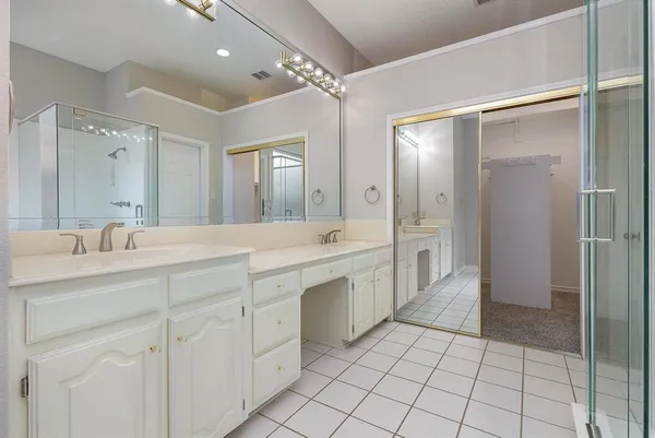 a spacious bathroom with a granite countertop sink mirror and