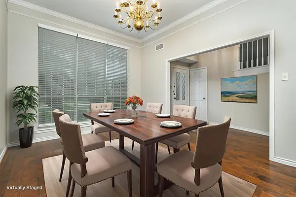 a view of a dining room with furniture window and wooden floor