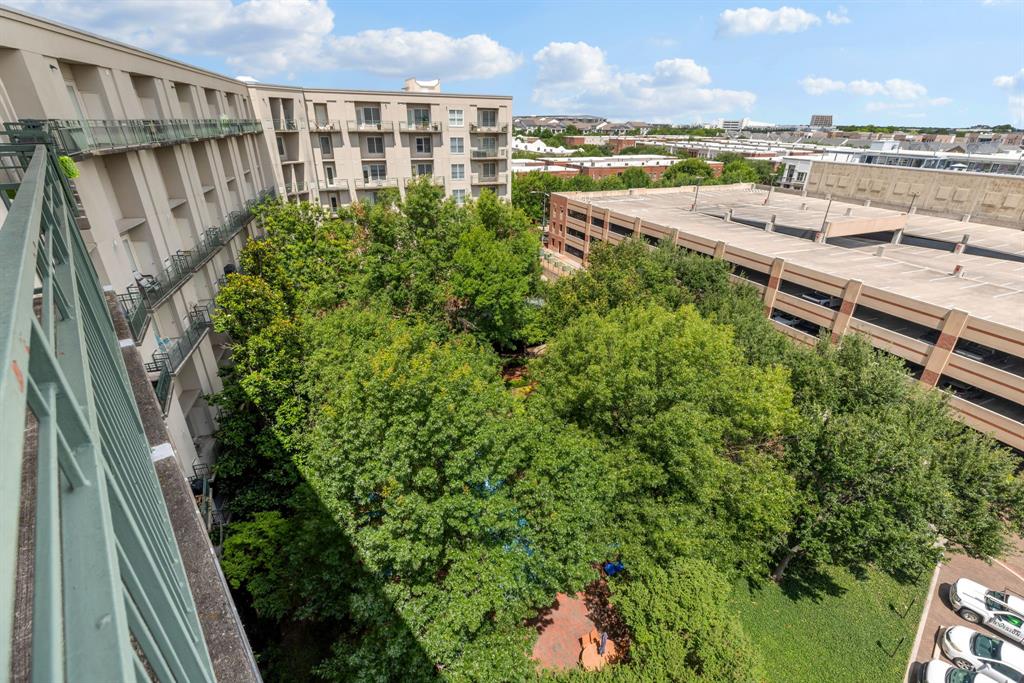 5055 Addison Circle, Unit 731 Addison, TX 75001 - Photo 31 of 40 View from the rear balcony down to the resident's courtyard. Beneath this canopy of trees you'll find a pool, firepit, seating areas and a grilling station.